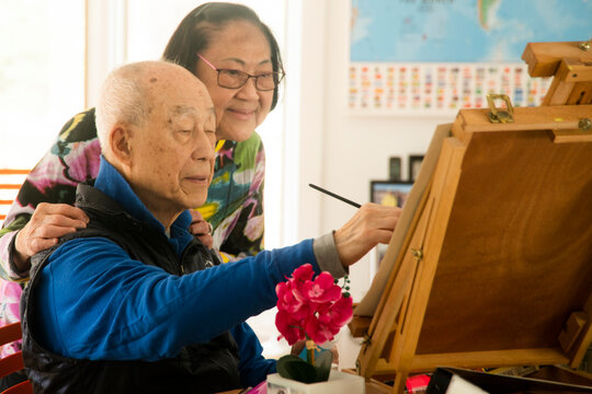 Senior retiree painting in the afternoon