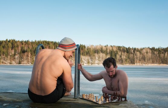 two men playing chess whilst cold water swimming in Scandinavia