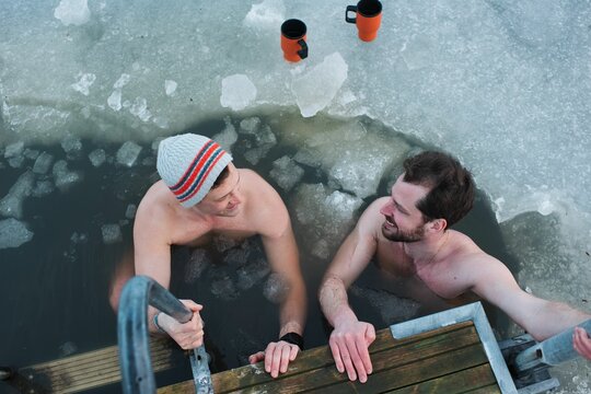 two male friends taking a cold water dip in the Baltic Sea