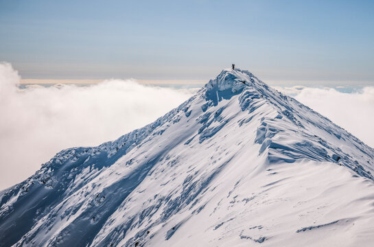 Tiny hiker dwarfed by winter summit of katahdin, maine