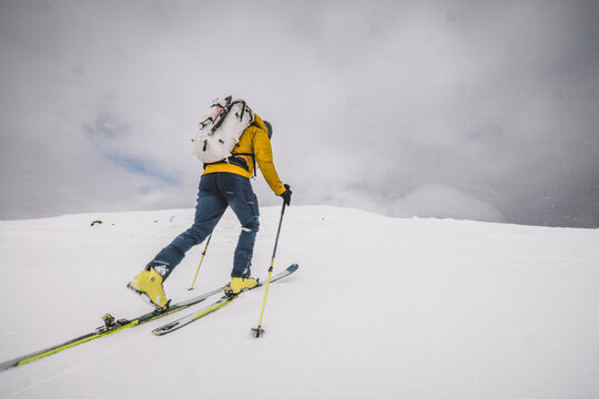 Man backcountry skis through snowy environment, Katahdin, Maine