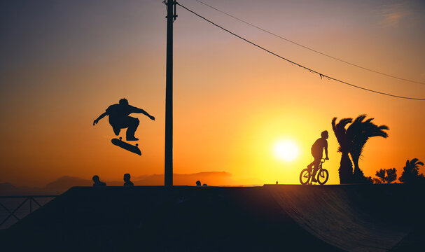 A group of teenage on skateboard at summer, silhouette unrecognizable.