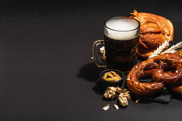 Traditional Oktoberfest set. Pretzels, beer, smoked pork knuckle eisbein with mustard