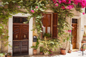 Fototapeta na wymiar Mediterranean house wall with flowers, Valletta Malta