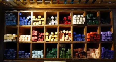 Shelving with sticks of colored lacquer wax for stamps and letters.