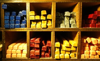 Shelving with sticks of colored lacquer wax for stamps and letters.