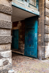 Old entrance with painted wooden doors in the ancient streets of Rouen in France