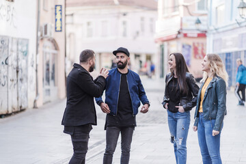 group of students are talking in the city center