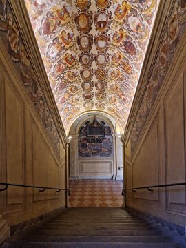 Arched staircase in old university building, Bologna, with ancient fresco's on ceiling