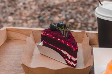 Red Velvet Cake decorated with beautiful blueberries on a wooden tray.