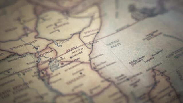 Kenya on a vintage political world map. Slow motion, tracking arc shot. 