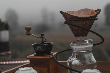 Bamboo drip jug for pouring coffee and kettle.Morning drip coffee set with a cold atmosphere in...