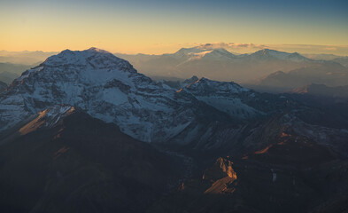 Aconcagua Peak from Andes Mountains at sunset. Aerial photo with the amazing sunset landscape over the tallest peaks in South America, part of Andres Mountains.