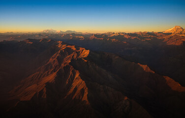 Aconcagua Peak from Andes Mountains at sunset. Aerial photo with the amazing sunset landscape over the tallest peaks in South America, part of Andres Mountains.