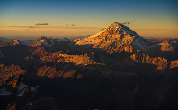 Aconcagua Peak from Andes Mountains at sunset. Aerial photo with the amazing sunset landscape over the tallest peaks in South America, part of Andres Mountains.