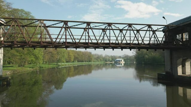 Camera passage under the bridge structure of a disused and collapsed lock on the Elbe River