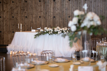 Main table at a wedding reception with beautiful fresh flowers. Wedding day.