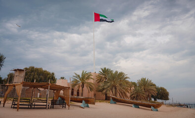 United Arab Emirates flag flying against sky. UAE celebrates it's national day on 2nd December every year. Emirates Heritage Club Heritage Village