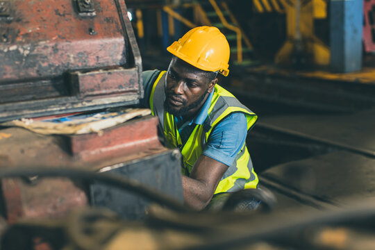 engineer male mechanic staff worker labor working in hevy industry dirty work place servicing large machine.