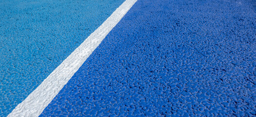 Sport field court background. Blue rubberized and granulated ground surface with white lines on ground. Top view - obrazy, fototapety, plakaty