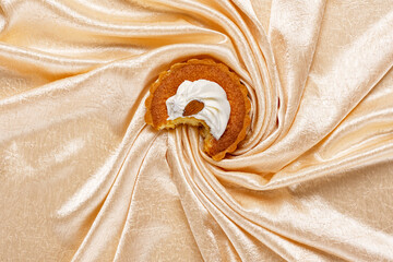 Creamy cheesecake cake on beige silk background
