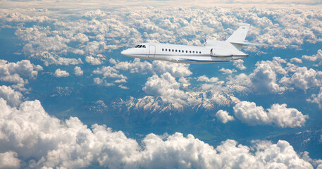 Fototapeta na wymiar Luxury design private jet flying over the clouds and sea