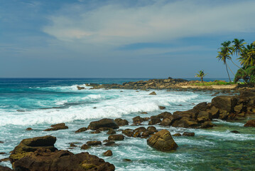 Wild rocky shore of the sea and cloudy sky