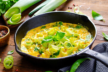 Omelette with Leek and Herbs, Delicious Snack or Breakfast on Rustic Wooden Background