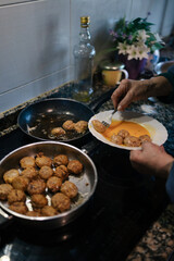 Old woman cooking meatballs