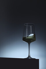 White wine in a transparent glass in low key