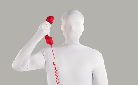 Person in faceless bodysuit disguise makes anonymous incognito phone call from unknown number. Strange unrecognizable young man wearing white spandex costume holding red vintage telephone receiver