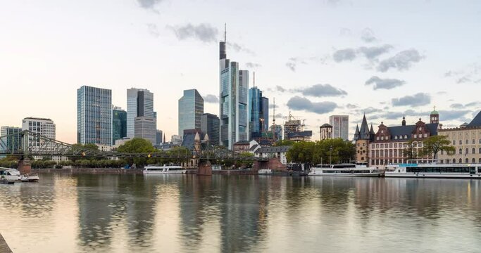 Golden hour hyper lapse of Frankfurt skyline in 4k. Iconic buildings and main river in cinematic motion time lapse.
