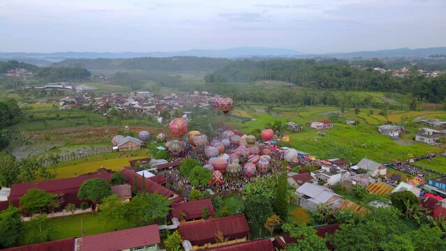 Drone shot of air balloon festival in Indonesia like the one in Cappadocia. Tourist attraction event - High altitude 4K Aerial view