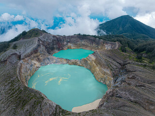 Crater lakes of stunning Kelimutu Volcanoes with Mountain Background in Flores Indonesia