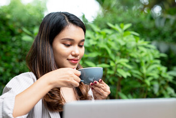 Asian businesswomen drink coffee while relaxing after work