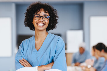 Happy female student proudly pursuing an education in healthcare