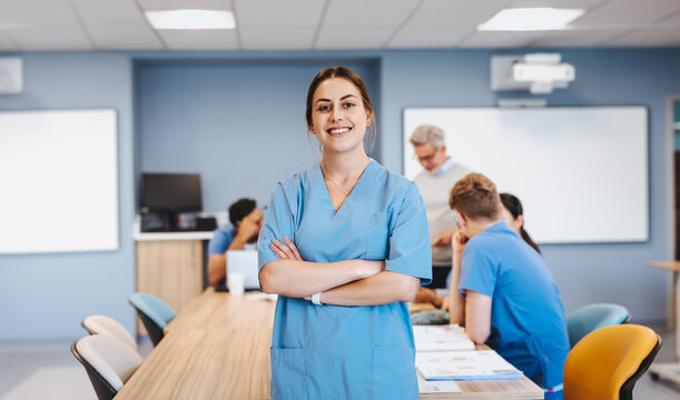 Portrait of a female medical student wearing scrubs in class