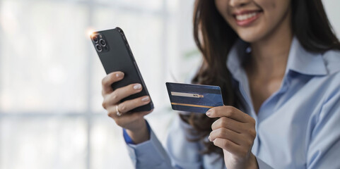 Asian woman shopping online retail store ecommerce using credit card debit card mobile smartphone smart payment transaction money cash transfer technology purchasing product beautiful happy smiling