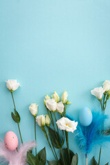 Flowers top view with easter eggs decor on blue surface