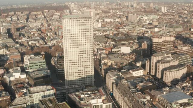 Circling aerial shot around Centre Point London revealing Oxford street