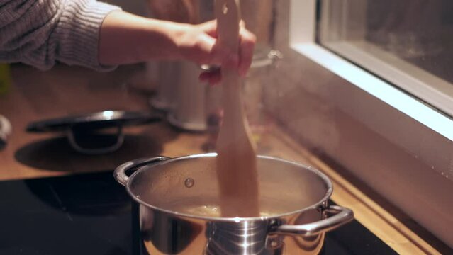 "Cooking up Penne: Slow Motion Close-up of Pasta Boiling in a Pot