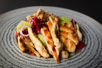 Close-up - Grilled chicken served with mixed salad and croutons