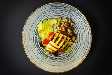 Top view - Grated haloumi cheese with mixed salad and croutons