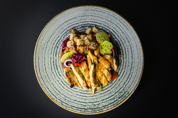 Top view- Grilled chicken served with mixed salad and croutons