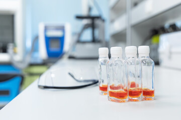 Glass bottles with orange solution use for test Coliform in water and ice. Water quality test in laboratory.