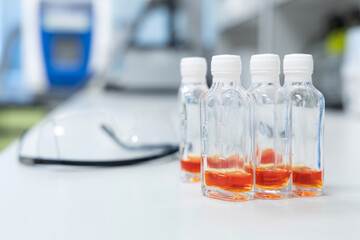 Glass bottles with orange solution use for test Coliform in water and ice. Water quality test in laboratory.