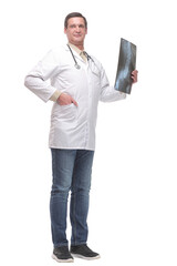 Attractive doctor examining an x-ray and looking at the camera