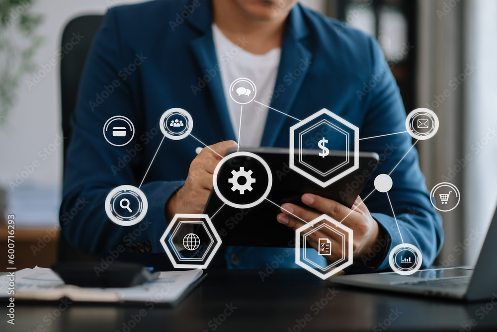 Poster close up of businessman working with laptop computer and smart phone on desk in office with virtual 