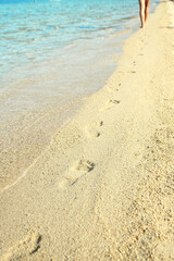 A Feet and footprints by the seashore in nature travel vacation background