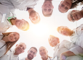 close up. group of doctors standing in a circle and looking at you